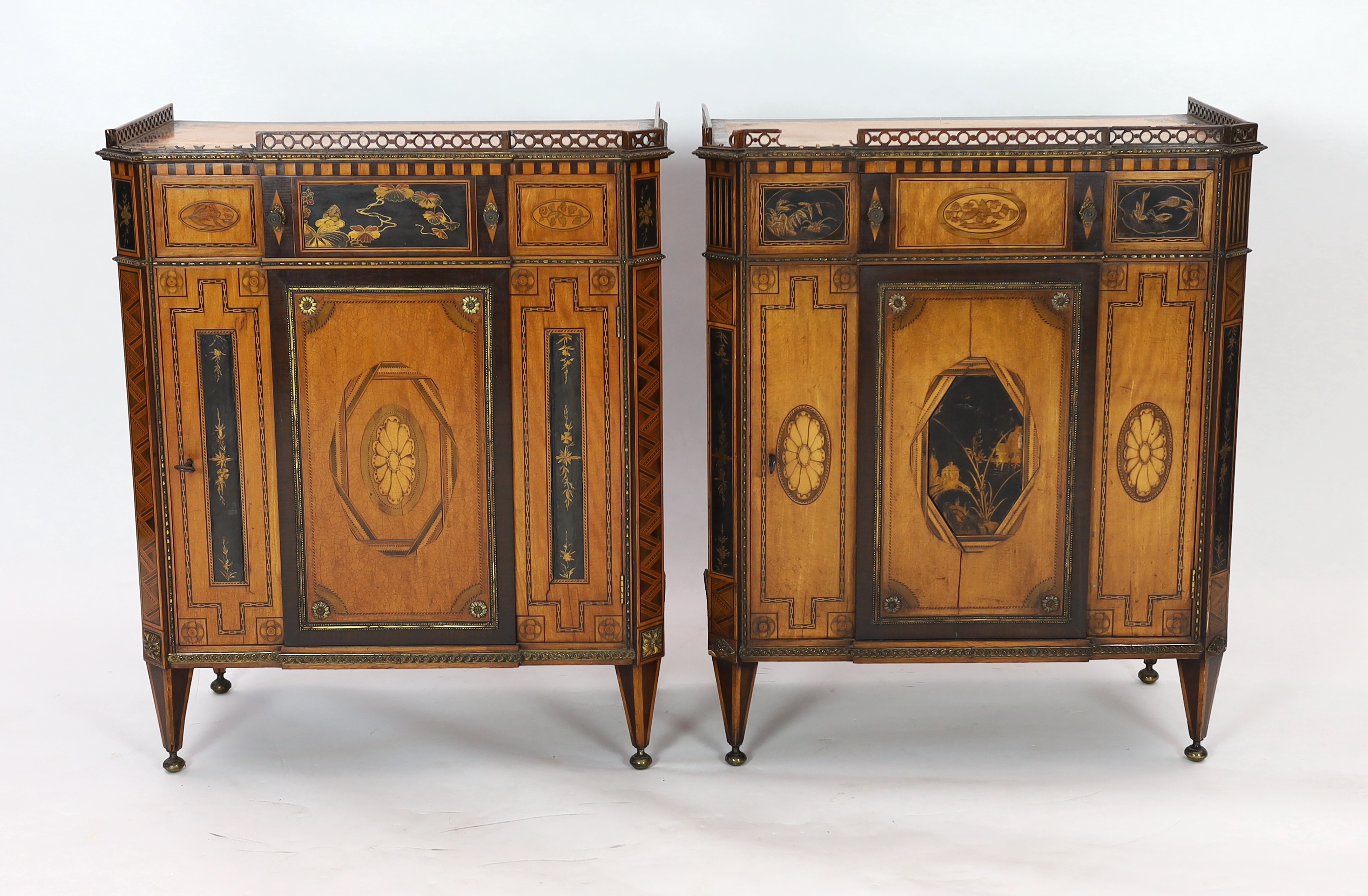 A pair of French Transitional style satinwood and marquetry side cabinets, 57cm wide, 40cm deep, 87cm high